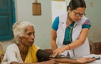 A doctor checking a tribal woman at Mobile Medical camp organised by MANT