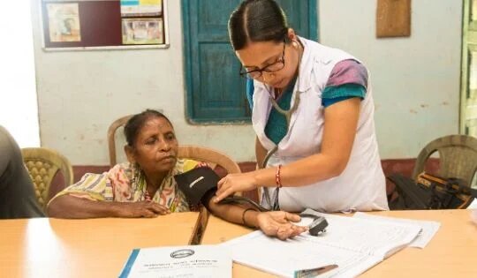 A woman doctor diagnosing a woman in a mobile medical camp by MANT