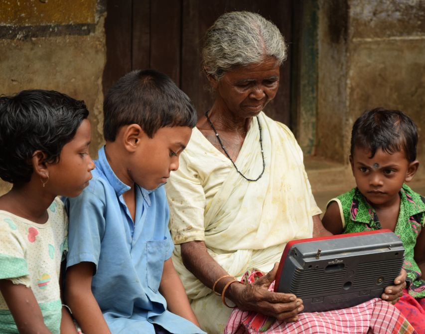 A santal family listening to radio